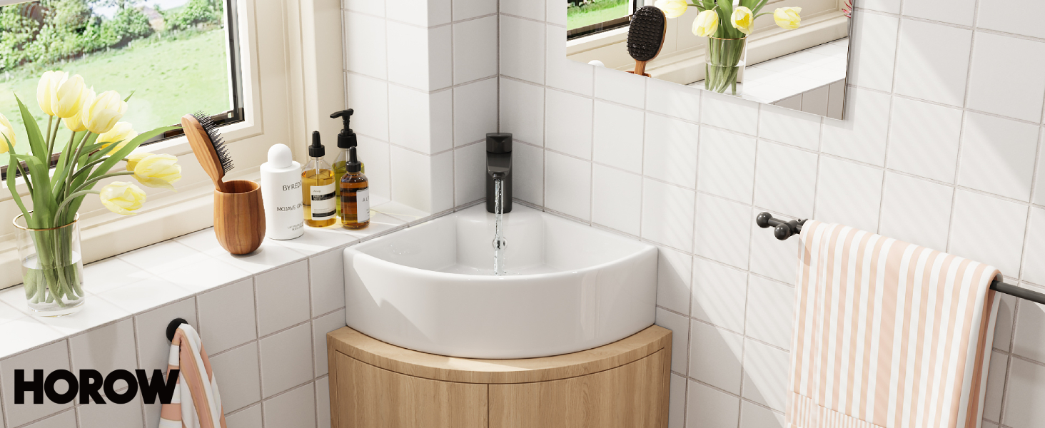 Modern corner bathroom with white tiled walls, featuring a triangular sink, black faucet, and wooden accents.