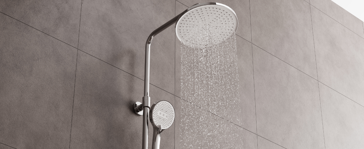 Similar view of rainfall shower head from different angle, highlighting the broad water spray pattern against gray tile backdrop.