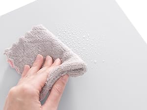 a person cleaning a towel with a cloth