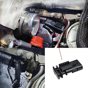 Close-up of automotive engine component with comparison image. Main image shows installed part in engine bay, with inset image showing detailed view of black plastic connector piece.