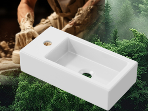 Rectangular white ceramic wall-mounted sink with single drain hole, photographed against natural outdoor background.