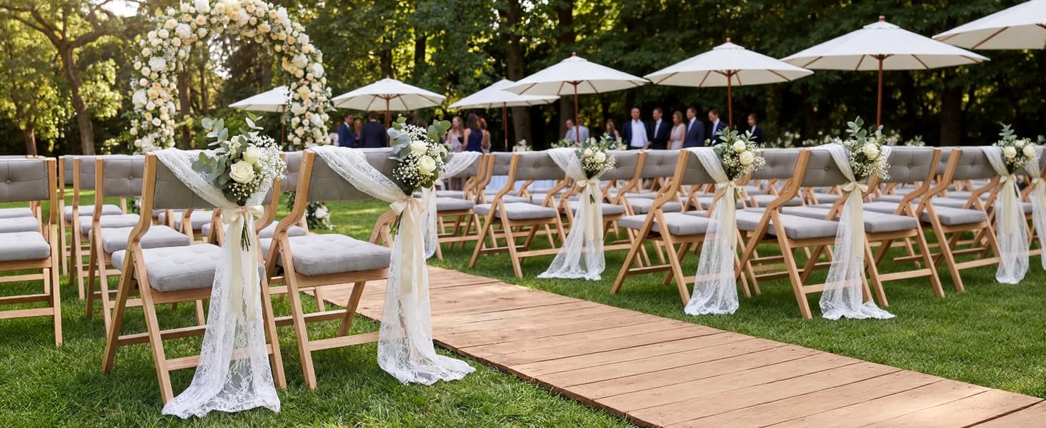 Outdoor event setup with white canopy tents and seating arrangements on grass. String lights create overhead lighting across multiple tents.