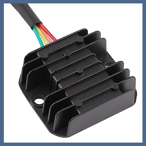 Black finned heat sink with multiple cooling fins and attached multicolored wires. Device likely used for heat dissipation in electronic components.
