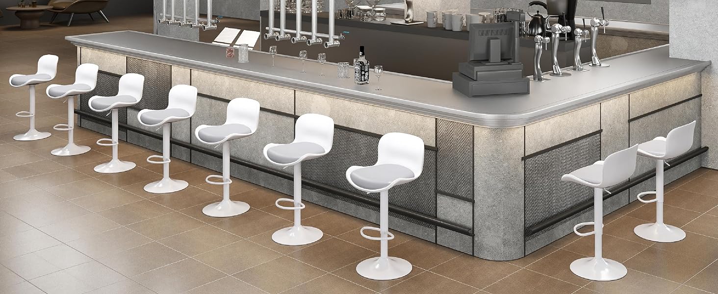 Modern commercial seating arrangement featuring white bar stools along grey concrete counter. Multiple views showing linear arrangement of seating with metallic accents.