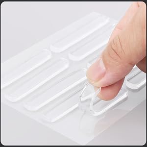 Close-up of a finger pressing a white, textured surface with raised rectangular shapes, possibly a tactile interface or keyboard.