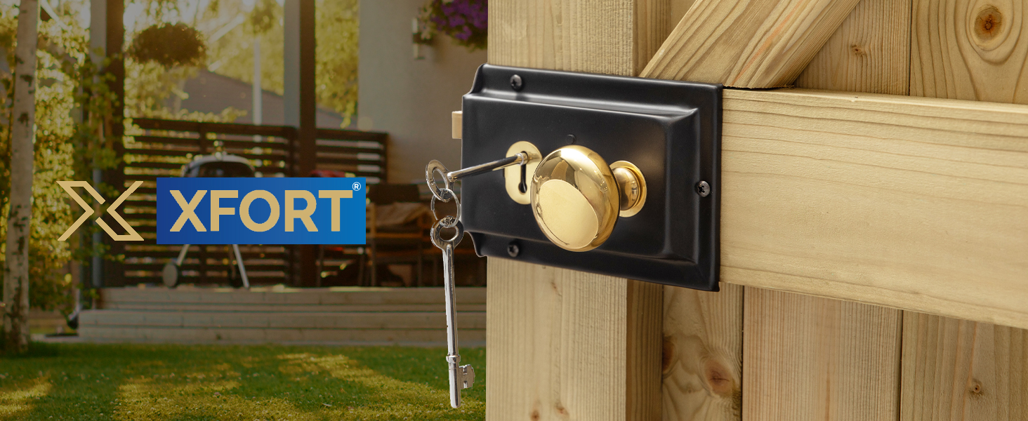 Black metal security lock with brass-colored cylinder mounted on wooden fence post. XFORT brand logo visible in background.