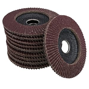 Stack of burgundy-red flap discs with dark center hubs, showing abrasive textile surface and center holes, used for grinding or finishing applications on various materials.