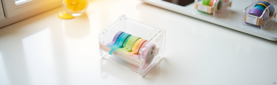 Clear plastic dispenser containing rainbow-colored washi tape rolls arranged horizontally, shown on white surface with minimal styling.