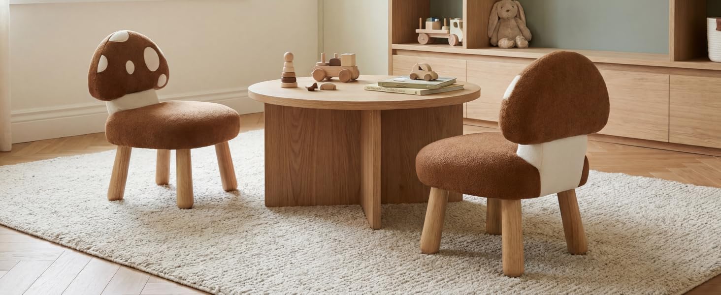 Two mushroom-shaped children's chairs in brown plush material positioned at a round wooden table. Set appears to be in a minimalist interior setting on a light carpet.