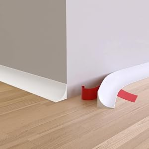Installation sequence showing white baseboard or molding being fitted between light wooden flooring and grey wall.
