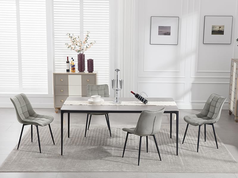 Elegant dining set featuring marble-top table with black metal legs, surrounded by six gray upholstered chairs in bright white room with window.
