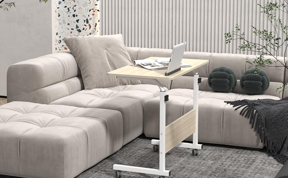 Modular light gray sectional sofa with tufted cushions, paired with a white adjustable side table. Set on a patterned rug in a minimalist room with textured walls.