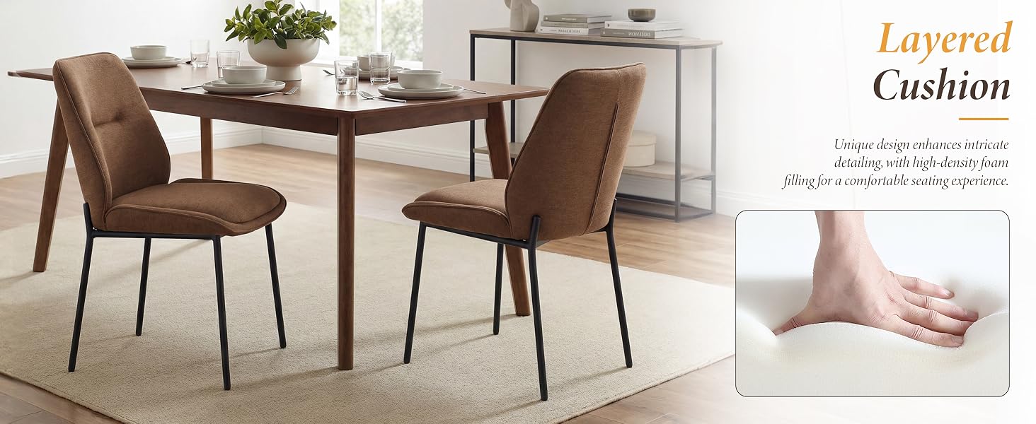 Text reads 'Layered Cushion'. Dining set with two brown upholstered chairs with metal legs flanking a dark wood table. Pink decorative pillow visible on chair.