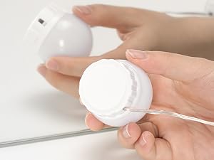 Series of close-up shots showing hands applying or demonstrating use of white cream or skincare product against light background.