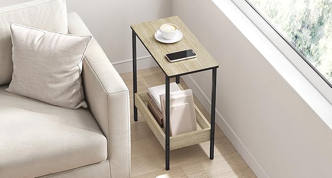 Modern living room interior featuring white upholstered sofa, side tables, and large windows. Clean, minimalist design with natural lighting.
