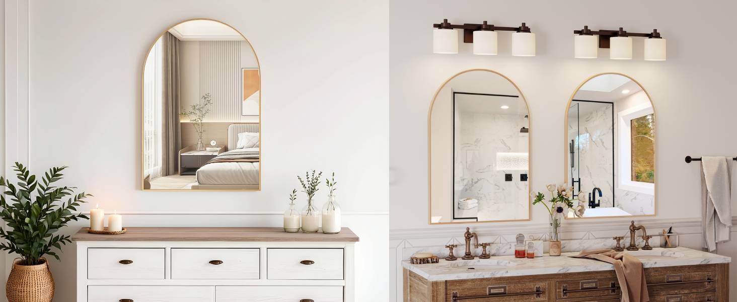 Two bathroom vanity setups with arched mirrors, wooden countertops, and white cabinets. Wall-mounted light fixtures above mirrors. Decorative plants and candles visible.