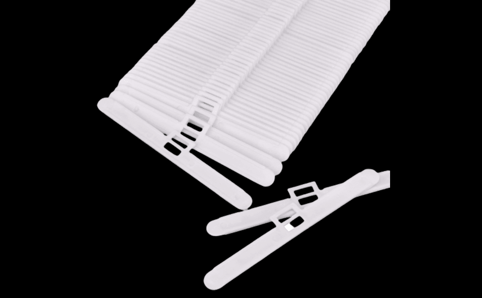 White plastic vertical window blinds slats with detachable clips, displayed against black background.