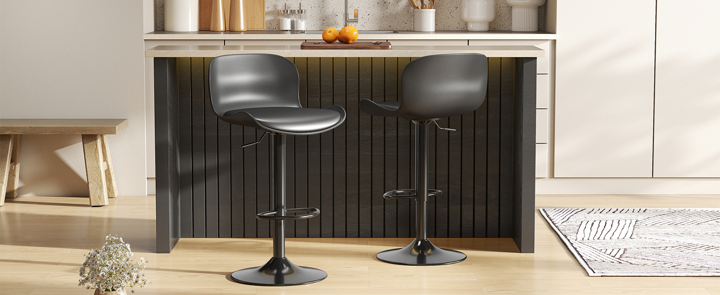 Modern kitchen counter setup with black paneled base and two adjustable height bar stools in metallic finish with round seats.