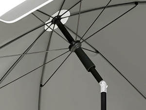 Close-up of umbrella canopy and frame. Metal spokes and fabric visible against light background, showing structural details.
