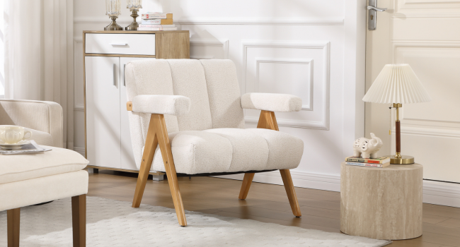 Interior scene showing white upholstered furniture including chairs and sofa in a bright, modern living room setting with wooden accents.
