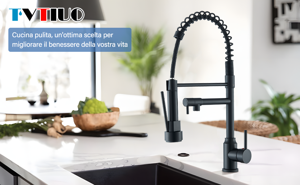 Grifo de cocina negro mate con rociador desplegable y diseño flexible de cuello de cisne, montado sobre una encimera blanca en una
