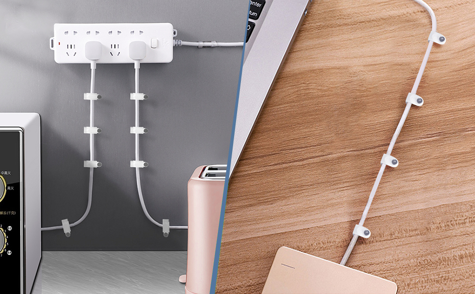 White cable management system with multiple clips attached to a desk. Shows organization of cords from electronic devices on a wooden surface.