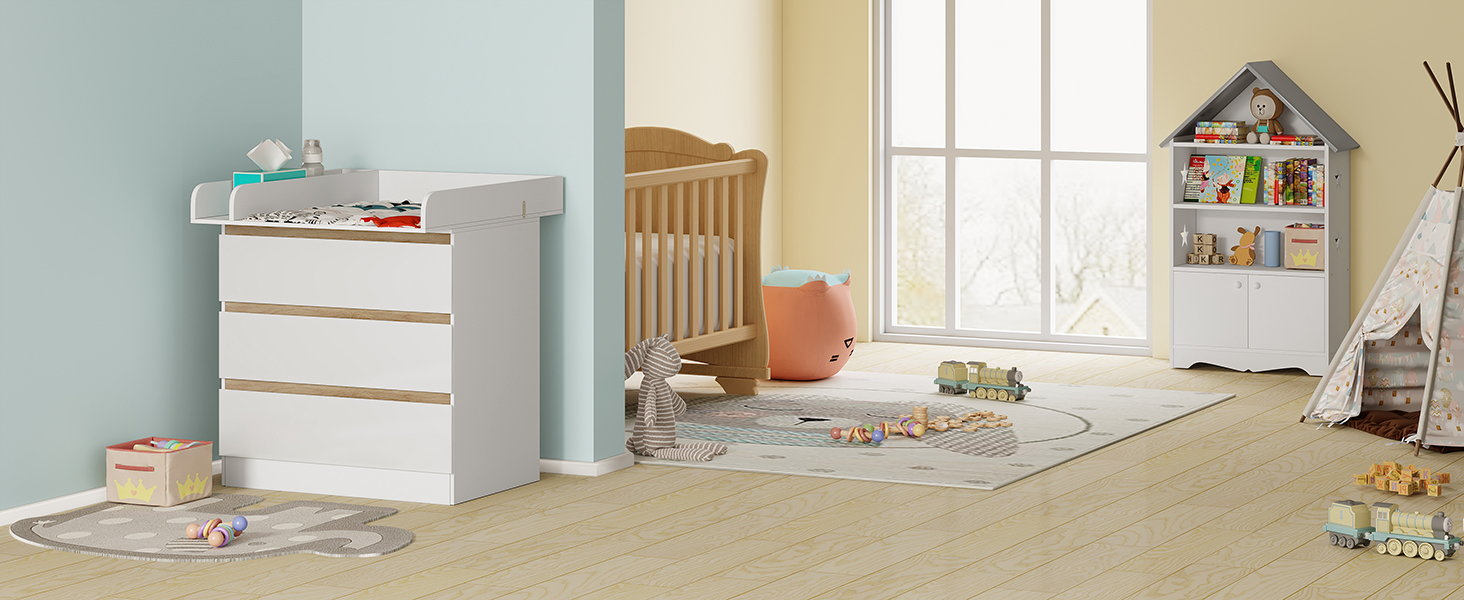 Baby nursery with white dresser, wooden crib, playmat, toys, and decorative house-shaped shelf. Room features pale blue walls and hardwood flooring.