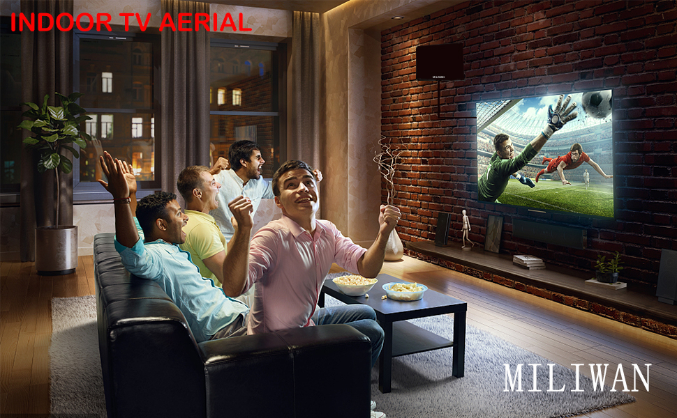 a group of people sitting in a room watching a movie on tv.