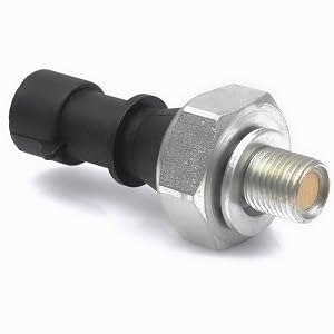Close-up of a metal and rubber automotive sensor or valve. Features a threaded metal base with a hexagonal nut and a black rubber tip.