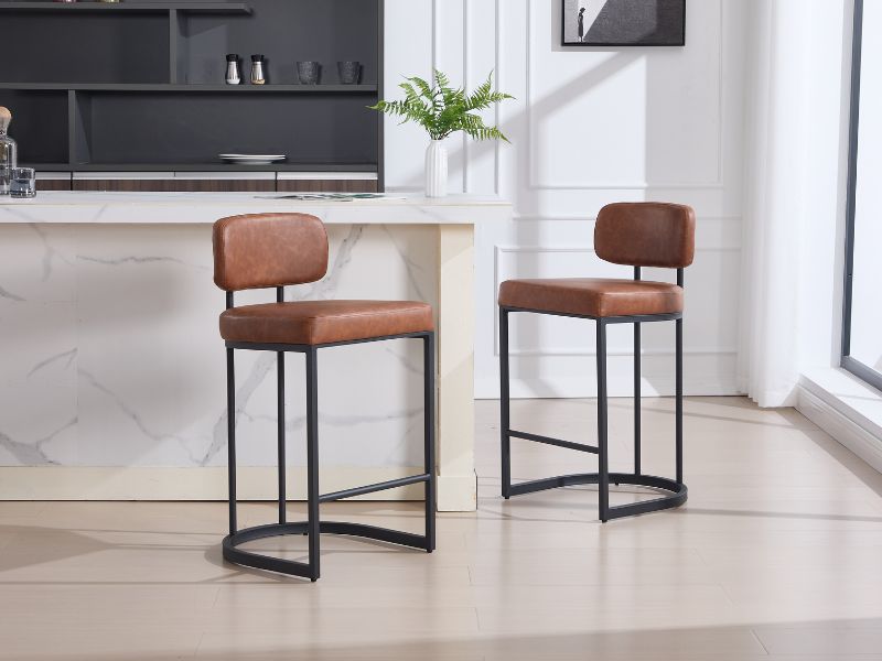 Modern minimalist dining area with brown leather dining chairs and black metal frame tables on light colored flooring. Clean, contemporary interior design.
