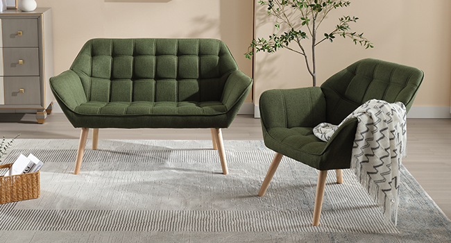 Modern olive green upholstered loveseat and armchair with tufted backrests and wooden legs. Furniture set features a quilted design and curved shape, displayed on a gray rug.