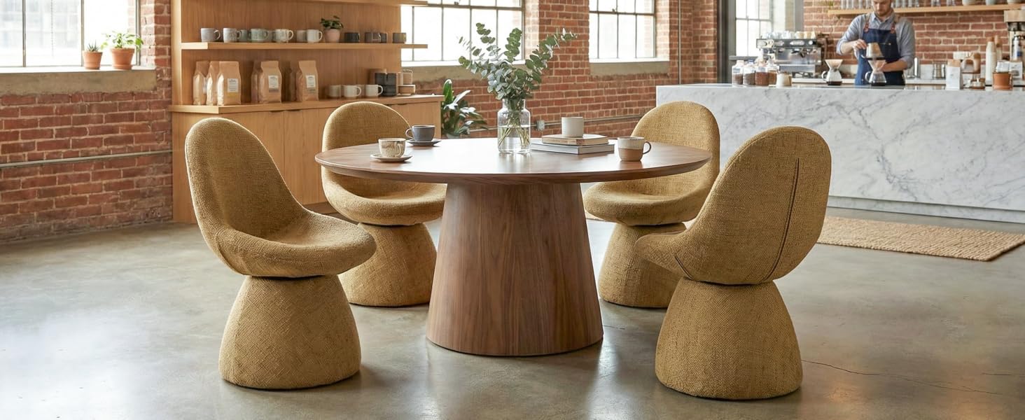 Modern dining area featuring uniquely designed cork chairs and round table. Industrial-style space with exposed brick walls and concrete flooring.