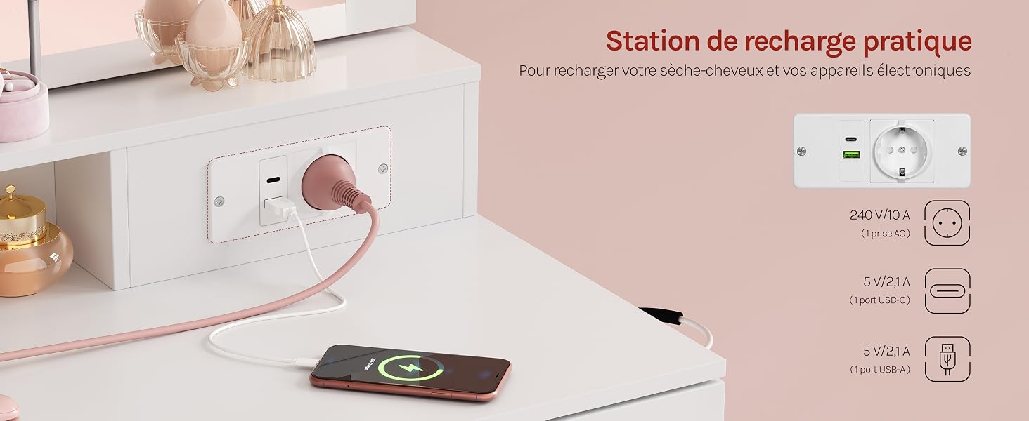 Le texte se lit comme suit : « Station de recharge pratique » et « Charge rapide », avec une partie du texte en français visible. Borne de recharge murale blanche avec touches roses, le smartphone se recharge en dessous sur une surface beige.