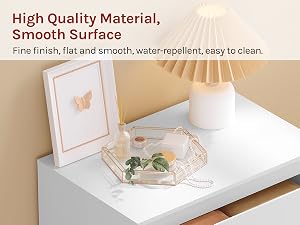 Text reads 'High Quality Material, Smooth Surface', 'Fine finish, flat and smooth, water-repellent, easy to clean.' White matte surface material sample with frame and decorative objects on display.