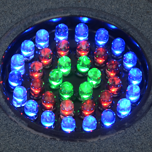 a close up of a circular light on a floor.