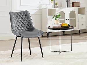 a black and grey chair with a black frame and a small table in front of it.