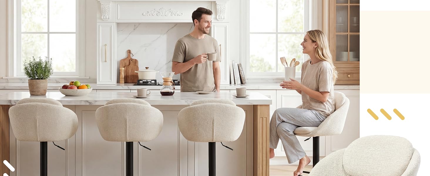 Intérieur de cuisine blanc moderne avec comptoir îlot et tabourets de bar, montrant une interaction décontractée dans un espace lumineux et bien éclairé.