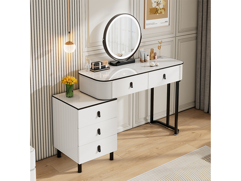 Modern white vanity table with illuminated round mirror, multiple drawers, black trim accents, and metal frame construction.