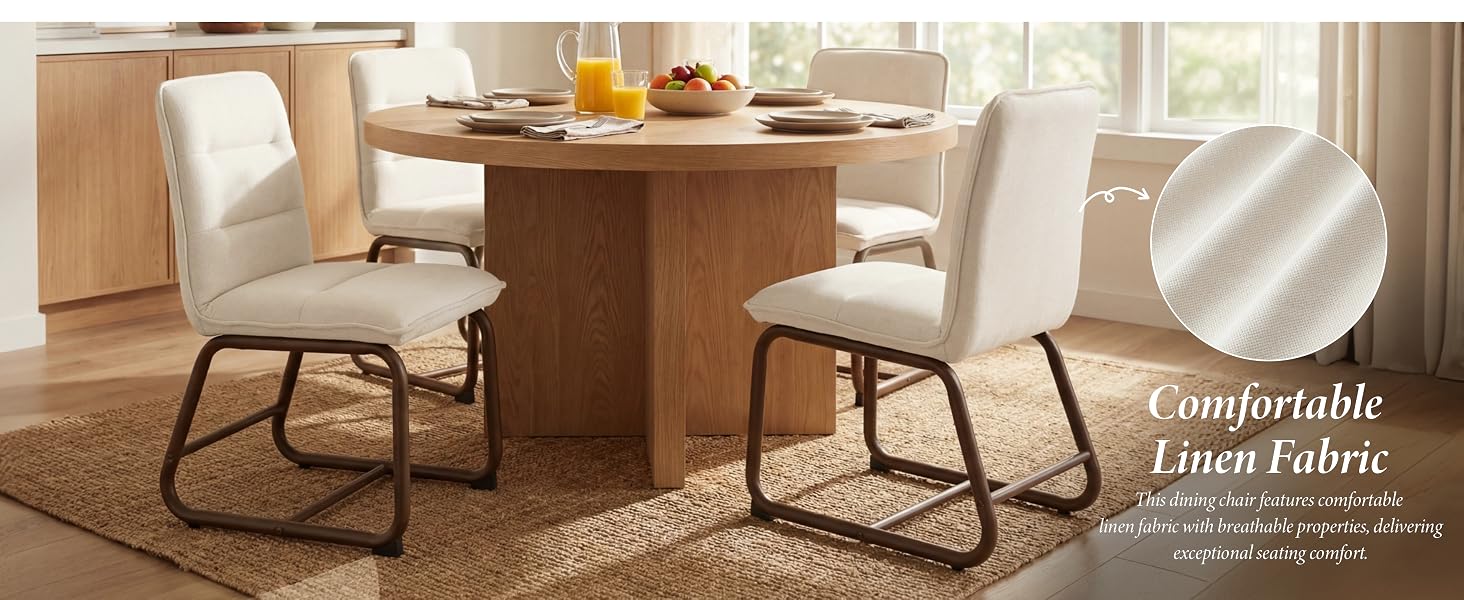 Text reads 'Comfortable Decor Item'. Modern dining area with wooden pedestal table and white upholstered chairs featuring sleek black metal frames.