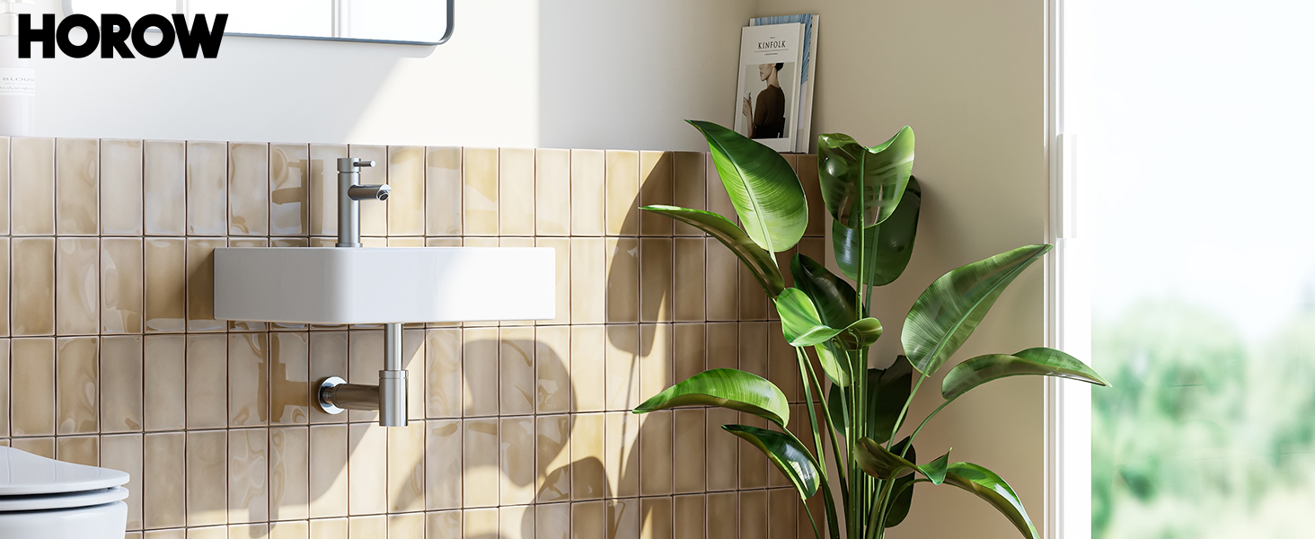 Modern bathroom interior with white tiled walls, featuring a large houseplant and mounted fixtures.