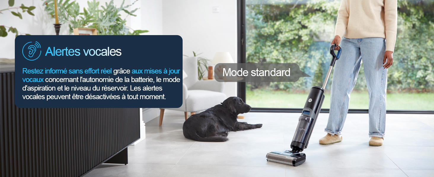 Le texte indique « Astérix vocales » et « Modo standard ». Aspirateur sans fil utilisé sur le parquet dans un intérieur de maison moderne avec de grandes fenêtres et une vue sur l'extérieur.
