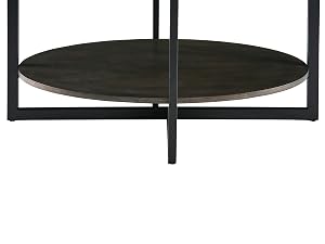 Modern round coffee table with dark textured top surface, metal frame, and matching lower shelf. Features minimalist design with cross-base support.