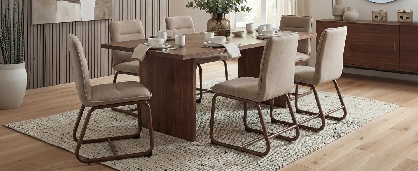 Modern dining room interior featuring beige upholstered chairs with metal frames around wooden dining tables. Multiple viewing angles of the same furniture set.