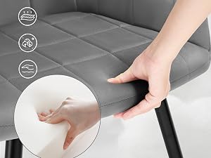 Primer plano de una mano que presiona contra un colchón de espuma gris, demostrando su suavidad y soporte. Los íconos sugieren características de enfriamiento, transpirabilidad y alivio de la presión