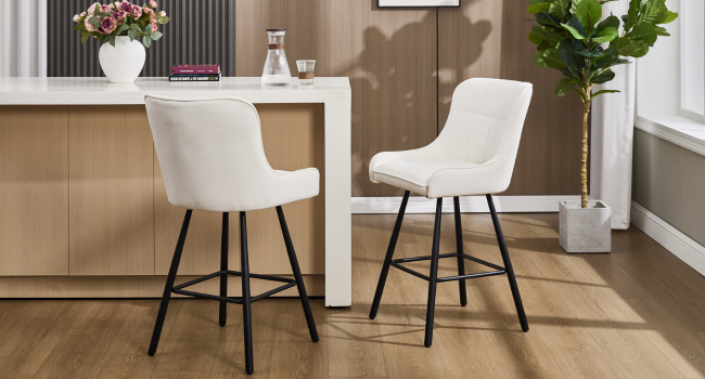 Modern interior setting with beige chairs and wooden flooring, showing comfortable seating arrangement.