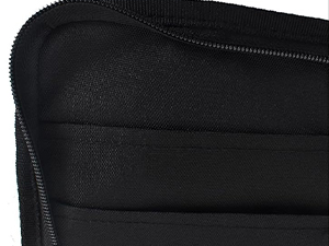 Close-up detail of black fabric material, appears to be part of a garment or accessory with zipper or seam detail.