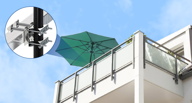 Green patio umbrella on a balcony or rooftop. Inset image shows a metal clamp or bracket, likely for securing the umbrella.