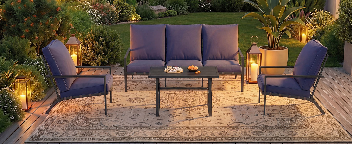 Outdoor patio furniture set with purple cushions, featuring sofa, chairs, and glass coffee table, illuminated by garden lighting.