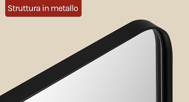 Il testo recita «Struttura in metallo». Primo piano dell'angolo della struttura in metallo nero con pannello di superficie bianco su sfondo beige, che mostra i dettagli del bordo metallico angolato.