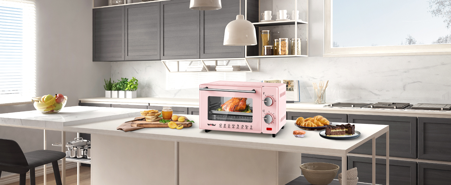 un forno rosa con una parte anteriore rosa si trova su un bancone della cucina.